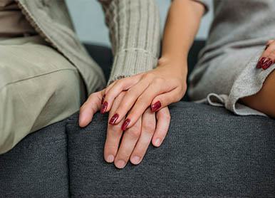A woman speaks to a man and another woman during a meeting