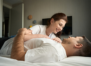 A woman writes notes on a whiteboard, focused and engaged in her task.