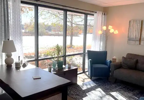 A woman speaks to a man and another woman during a meeting